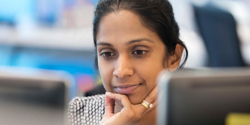 A person looks intently at a computer screen.