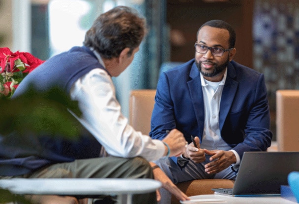 An advisor and a client sit together having a discussion.