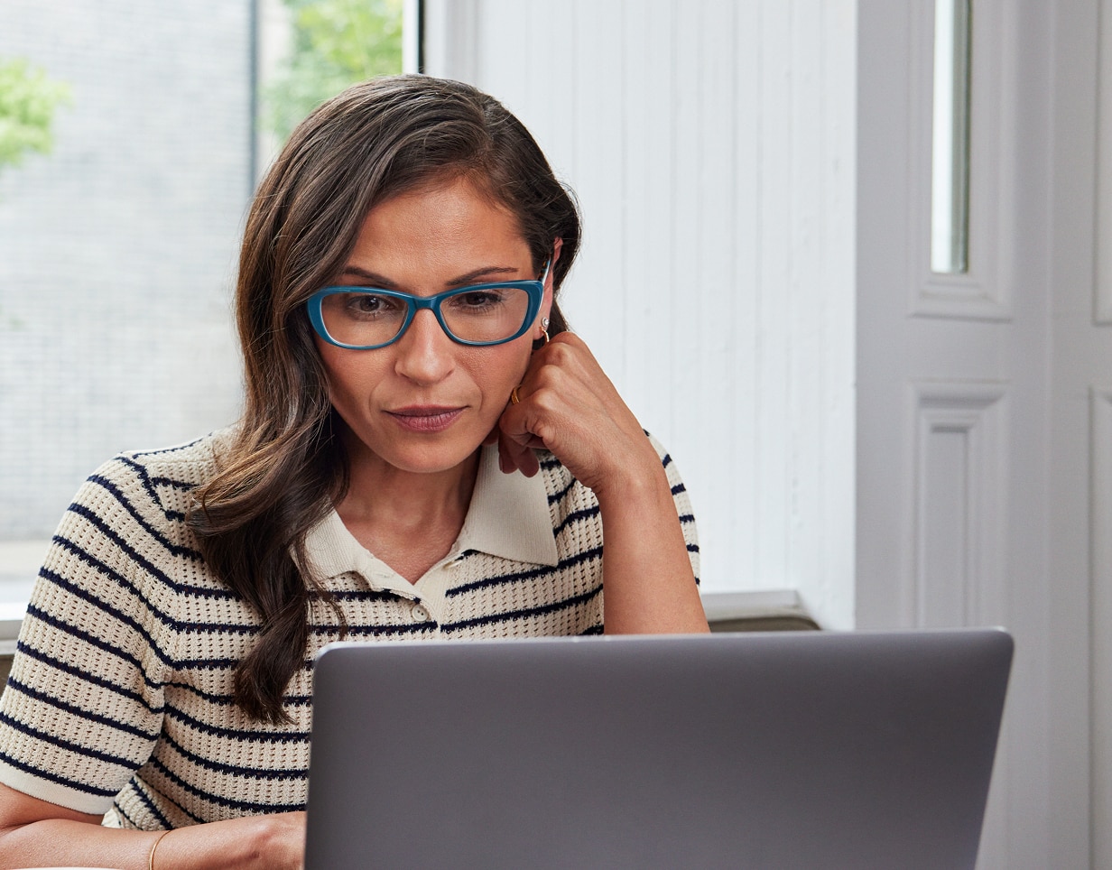 A participant working on their laptop in their home.