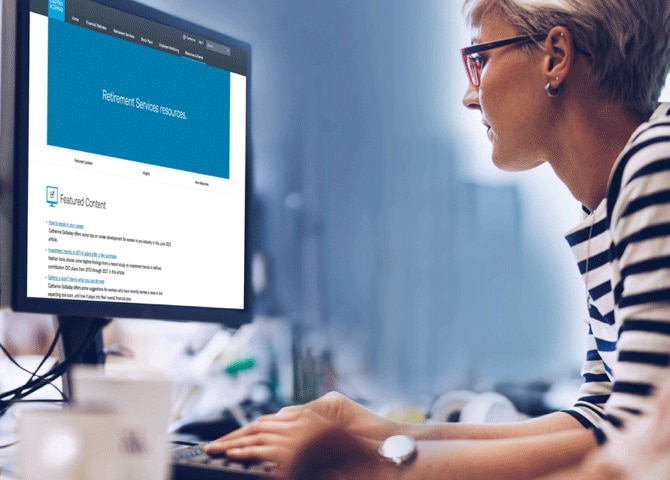 A person sits at a computer typing.