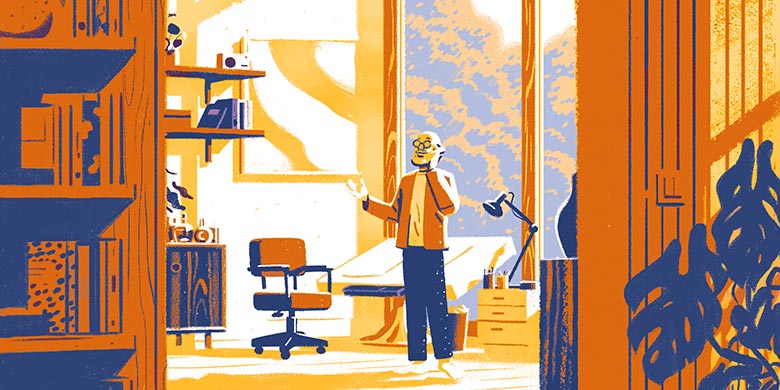 An older man talking on the phone in his home office.